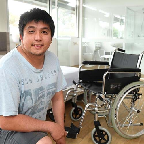 William Lin in front of wheelchair